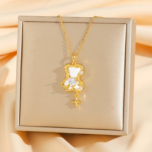 Golden bear necklace with heart zircon and star pendant on luxury satin background