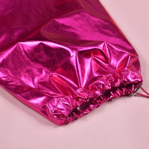 Close-up of metallic magenta fabric with silver drawstring toggle on the shiny pants