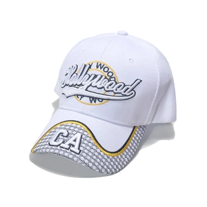 White baseball cap with Hollywood embroidery and yellow brim detail in street style