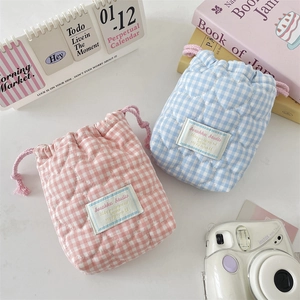 Detailed view of pink and blue quilted heart drawstring storage bags for cameras
