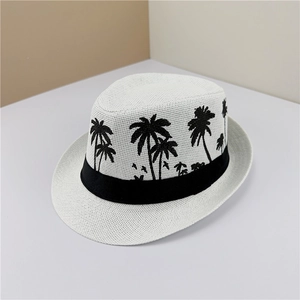 Detailed view of white straw fedora featuring black palm tree embroidery and band