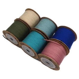 Detail of 1.5mm cotton weaving cords in various colors on paper spools for DIY jewelry