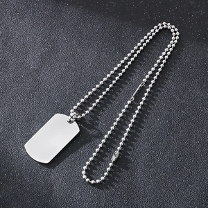 Detailed close-up of a polished stainless steel military dog tag with a silver ball chain