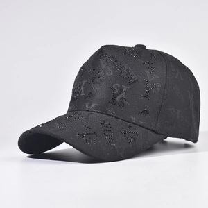 Close-up of sparkling rhinestone YS embroidery and fashion letters on black baseball cap