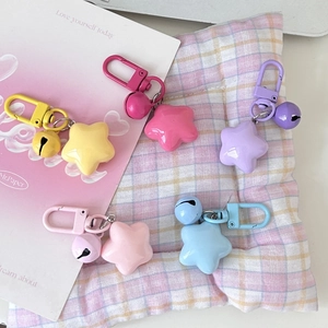 Close-up of candy-colored star keychains with matching bells and metal clips in five colors