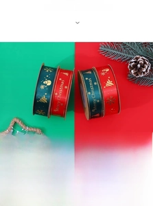 Close-up of red and green Christmas ribbons with gold snowflake and snowman prints