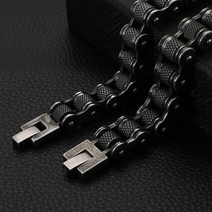 Detailed macro shot of vintage bicycle chain bracelet with textured rollers and fold-over clasp
