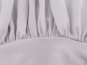 Detail of lavender tulle bodysuit showing pleated chiffon and knit fabric stitching
