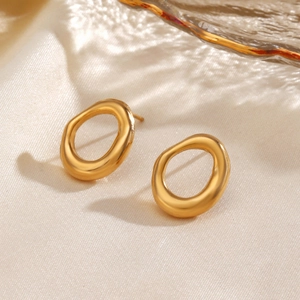 Minimalist 18K gold plated oval earrings made of stainless steel on beige silk