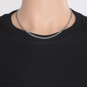 Close-up of 50cm long and 4mm wide silver cuban curb chain necklace for men on a model