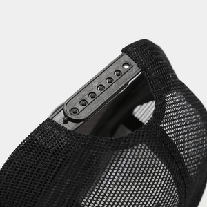 Detail of adjustable plastic snapback closure and breathable mesh on a black baseball cap