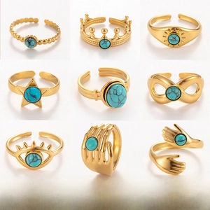 Collection of nine gold stainless steel rings with natural stones in various crown designs
