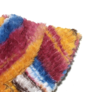 Macro shot of vibrant multi-color striped faux fur texture with soft plush faux fur fibers