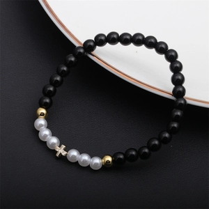 Fashionable beaded bracelet with black agate, pearls and golden cross pendant charm