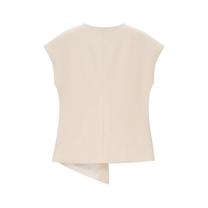 Detail view of cream sleeveless top featuring an asymmetric hem and soft draped fabric