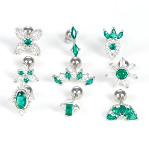 Set of stainless steel cartilage piercings with green zircon and daisy floral designs