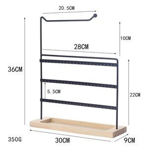 Three-tier black metal earring organizer with wooden base and dimensions shown