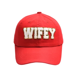 Detail of red cotton baseball cap featuring white plush WIFEY letter embroidery with gold sequins