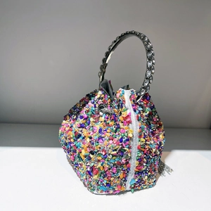 Detailed shot of colorful gemstone bucket bag with sparkling rhinestone circular metal handle