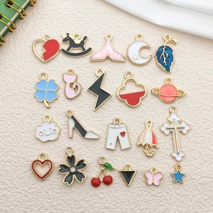 Detail of diverse enamel charms including hearts and flowers with gold trim