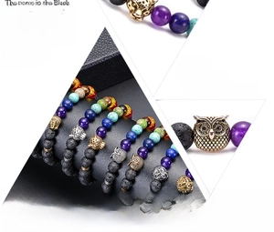Macro shot of lava stone bead bracelets featuring metal leopard and lion charms
