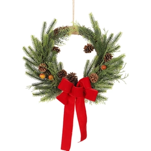 Christmas wreath with pine needles, cones, berries and a red velvet bow for home decoration