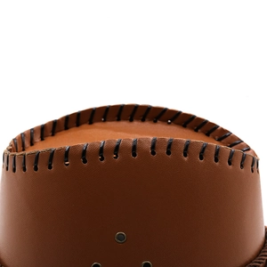Close-up of brown leather cowboy hat crown with black stitching and metal eyelets