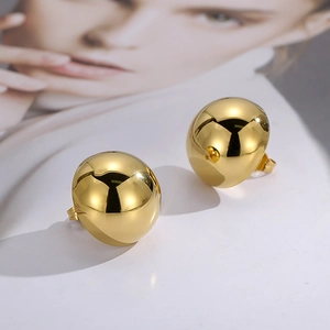 Classic gold hollow semi-sphere stud earrings with a polished finish on white background