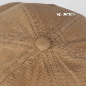 Detail of the khaki cotton baseball cap top button and reinforced stitched seams