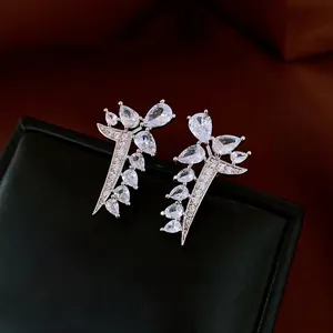 Elegant silver leaf stud earrings with pear-cut cubic zirconia on a black jewelry box
