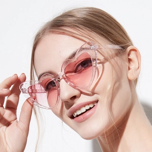 Pink glitter heart-shaped sunglasses with gradient lenses and clear sequin frames
