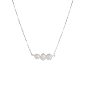 Close-up of three white freshwater pearls on a delicate 925 silver necklace chain
