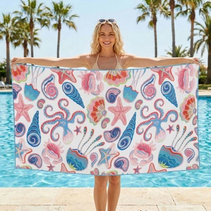 Detail showing microfiber beach towel with colorful sea life print by the pool