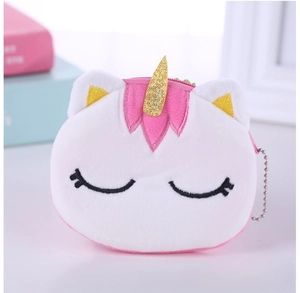 Close-up of white plush unicorn coin purse with golden horn and pink ears details