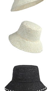 Detail of lace sun hat with floral mesh and white pearl trim on the brim edges