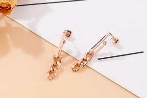 Detail view of rose gold titanium chain earrings with sleek linear and linked metal design