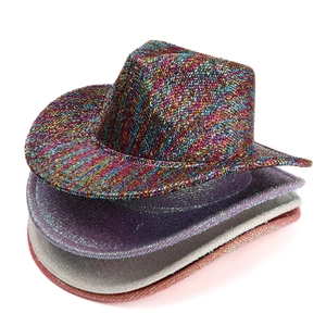 Stack of sequined western cowboy hats in rainbow, purple, silver, and coral colors