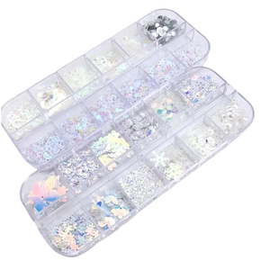 Detailed view of three plastic organizers filled with holographic nail art sequins and charms