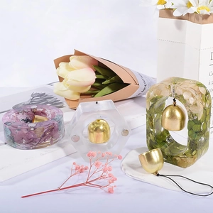 Detail of DIY resin doorbell molds with dried flowers and golden metal bells
