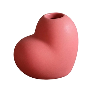 Pink heart-shaped ceramic vase with matte texture and minimalist design for home decor