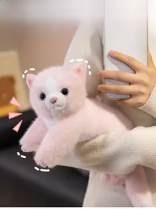 Close-up of fluffy pink and white Persian cat plush toy with realistic blue eyes