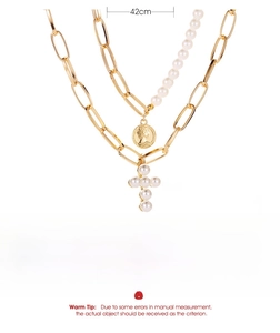 Detailed view of gold multi-layer necklace with portrait coin and pearl cross pendant