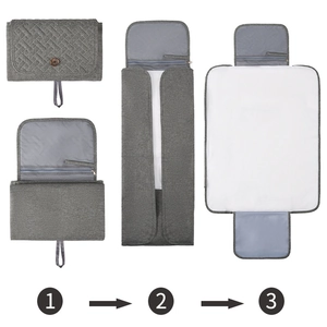 Portable gray folding baby changing mat with waterproof lining and storage pockets