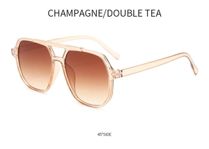 Detail view of champagne pilot sunglasses with double tea gradient lenses and frame