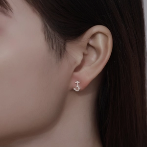 Minimalist 999 sterling silver anchor stud earrings with pavé details on model