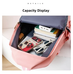 Internal view showing large storage capacity of pink nylon school backpack with daily essentials