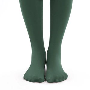 Detail view of dark green thermal leggings featuring a seamless footed design and matte finish