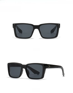 Detailed view of black square sunglasses featuring three gold dot rivets on the temples