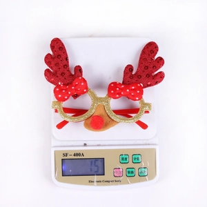Detailed view of Christmas reindeer glasses weighed on a scale showing 15g product weight