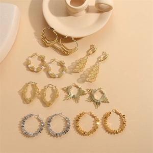 Modern gold and silver spring earrings set with spiral hoops and pearl accents